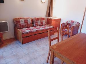 a living room with a couch and a table at Apartment Termignon ski-in ski-out location in Val Cenis +14 photos