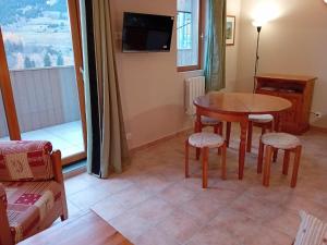 a living room with a table and chairs and a tv at Holiday home in Val Cenis for 4 people in Val Cenis +12 photos