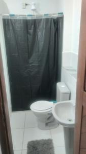 a bathroom with a toilet and a sink at Studio 4 pessoas in Salvador