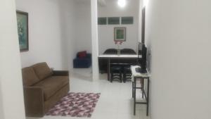 a living room with a couch and a table at Studio 4 pessoas in Salvador