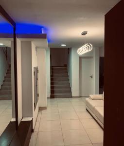 a living room with a bed and a blue light at Valentino Apart 1 in Villa María