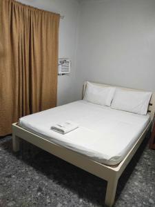 Ένα ή περισσότερα κρεβάτια σε δωμάτιο στο Ohana Rooms