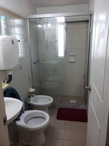 a bathroom with a shower and a toilet and a sink at Frente al mar in Montevideo +104 photos