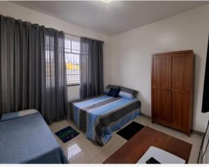 a bedroom with a bed and a cabinet and a window at Linda casa para COP 30 in Belém