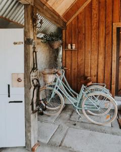 a blue bike parked in a wooden garage at Simplistic Luxury Cottage, Ross in Ross
