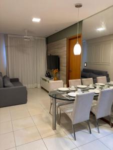 a living room with a table and chairs and a couch at Flat Rosarinho II - Confortável e Super Completo in Recife