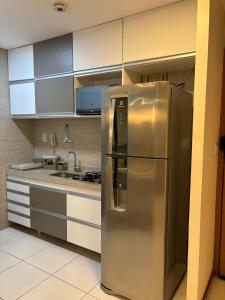 a stainless steel refrigerator in a kitchen at Flat Rosarinho II - Confortável e Super Completo in Recife