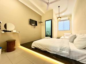 Ένα ή περισσότερα κρεβάτια σε δωμάτιο στο Bahari 58