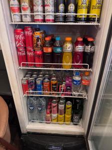 a refrigerator filled with lots of different types of drinks at Pousada Recanto do Canário 2 in Governador Celso Ramos