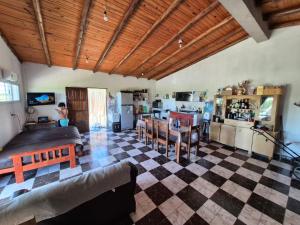 ein Wohnzimmer mit einem karierten Boden und eine Küche in der Unterkunft El Retoño in Esquina