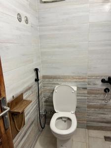a bathroom with a white toilet in a stall at Ge boho house in Dahab +24 photos