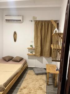 a bedroom with a bed and a window at Ge boho house in Dahab