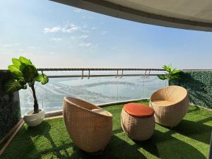 a balcony with chairs and a view of the mountains at Luxury Vello Stay Supernova in New Delhi