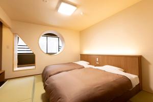 Postel nebo postele na pokoji v ubytování Ooedo Onsen Monogatari Premium Yamanaka Grand Hotel