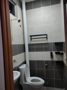 a bathroom with a toilet and a sink at Puteri Homestay in Kangar +30 photos