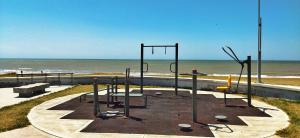 a playground on the beach next to the ocean at Alfonsina y el Mar in Mar del Plata