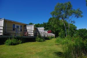 a house with a deck and a yard at Hedley House Inn in Smiths Cove