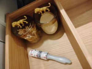 a bottle of medicine and a syringe in a drawer at La nuitée à la ferme in Érezée