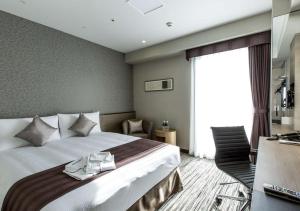 Cama o camas de una habitación en The Strings Hotel Nagoya