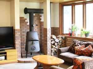 a living room with a wood stove in a room at Pension Come Healing Tatami-room- Vacation STAY 14980 in Minami Uonuma