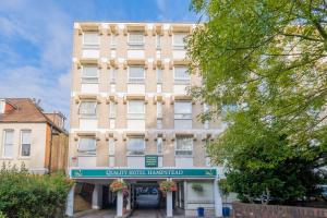 a tall building with a sign in front of it at Quality Hotel Hampstead in London
