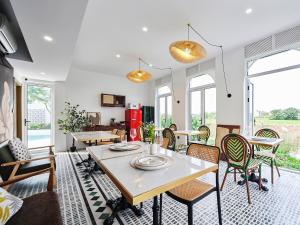 a living room with a table and chairs at Muse Garden in Shanghai
