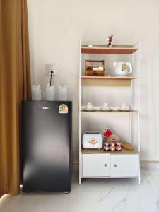 a black refrigerator in a room with a shelf at หลงเขา Chiang Dao in Ban Thung Lakhon +9 photos