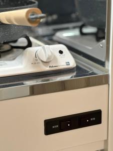 a computer mouse sitting on top of an appliance at 新大久保から徒歩7分の新しいアパート1 in Tokyo