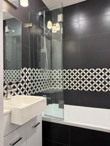 a bathroom with a sink and a glass shower at Perfect Potts Point Pied-à-terre in Sydney +9 photos