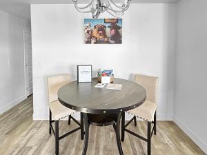 a dining room table with two chairs and a black table at Bark and Bike Abode home in Fruita