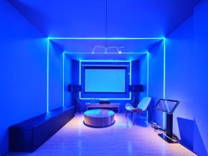 a blue room with a table and a tv at Muse Garden in Shanghai