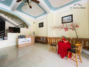 a dining room with a table and chairs and a ceiling at Vi TamCoc Hotel in Ninh Binh