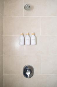 a shower with two white bottles on the wall at The Soul of Kingston Chic 2BR Condo with Pool and GYM in Kingston