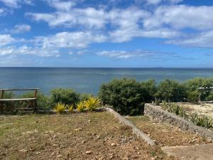 a view of the ocean from a hill with a bench at SiQUIJOR SEA SHORE HOUSE in Siquijor