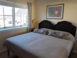 a bedroom with a bed with two pillows and a window at No1Dornoch in Dornoch