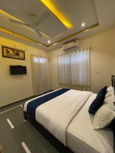 a bedroom with a large white bed and a window at Tasya Villa in Udaipur +15 photos