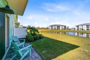 a porch with two blue chairs and a body of water at Margaritaville Florida Getaway in Orlando
