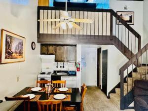 a kitchen with a dining room table and a staircase at Treetop Condo in Yosemite-Sleeps 6-Balcony in Yosemite West