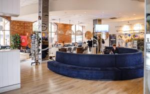 a lobby with a blue couch in the middle at Wake Up! Sydney Central in Sydney