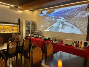 a table in a restaurant with a large screen at Bamboo-Hill -OT- in Nozawa Onsen