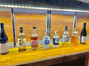 a group of bottles of alcohol sitting on a counter at Bamboo-Hill -OT- in Nozawa Onsen