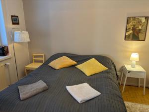 a bedroom with a bed with two pillows on it at Valimontien residenssi in Kouvola