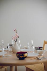 a wooden table topped with glasses and a table with a table at Coda House in Aoichō