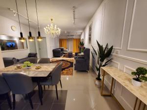 a living room with a table and a dining room at farissa homestay in Malacca