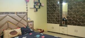 a bedroom with a bed and a large mirror at sushma's homestay in Prayagraj +1 photo