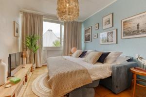 a bedroom with a large bed and a chandelier at Koté Vagues - Appt pieds dans l'eau in Saint-Gilles les Bains