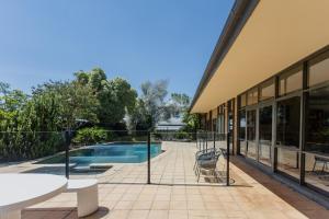 a patio with a swimming pool and a building at Yarra Valley Grand in Yarra Glen