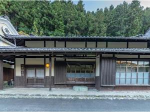 a building with a lot of windows and trees at 河辺ふるさとの宿 in Ōzu +57 photos