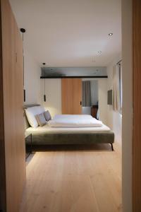 a bedroom with a large bed in a room at das 1494 Wohnen und Kultur im Denkmal in Mieming