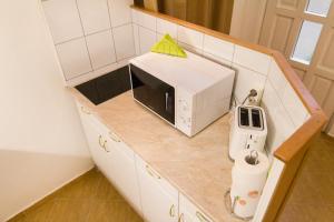 a small kitchen with a microwave on a counter at Authentic Grand Boulevard in Budapest